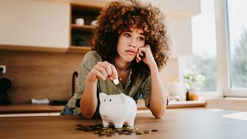 Woman saving money in piggy bank