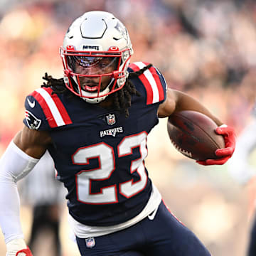 Jan 1, 2023; Foxborough, Massachusetts, USA; New England Patriots safety Kyle Dugger (23) runs for a touchdown after intercepting the ball during the second half of agame against the Miami Dolphins at Gillette Stadium. Mandatory Credit: Brian Fluharty-Imagn Images
