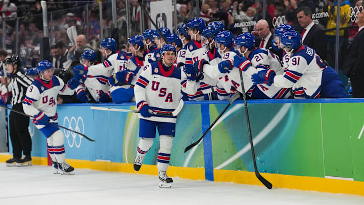 Feb 20, 2026; Milan, Italy; Jack Hughes (86) of the United States celebrates with the bench after scoring a goal during the second period against Slovakia in a men's ice hockey semifinal during the Milano Cortina 2026 Olympic Winter Games at Milano Santagiulia Ice Hockey Arena. Mandatory Credit: James Lang-Imagn Images