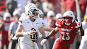 Oct 4, 2025; Louisville, Kentucky, USA; Virginia Cavaliers quarterback Chandler Morris (4) looks to pass against Louisville Cardinals defensive lineman Wesley Bailey (23) during the first quarter at L&N Federal Credit Union Stadium. Mandatory Credit: Jamie Rhodes-Imagn Images