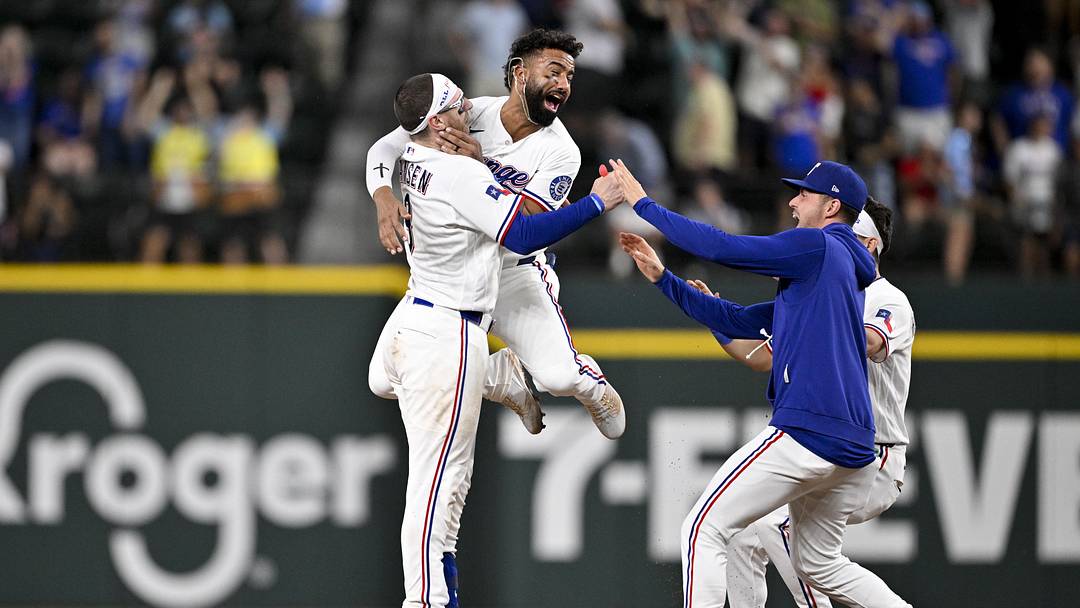 Texas Rangers catcher Danny Jansen (9) and second baseman Ezequiel Duran (20) and starting pitcher MacKenzie Gore (1) and center fielder Sam Haggerty (0) celebrate after Jansen hits a single and drives in the game winning run against the Arizona Diamondbacks.