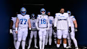 Detroit Lions center Frank Ragnow (77), quarterback Jared Goff (16), and offensive tackle Penei Sewell (58).