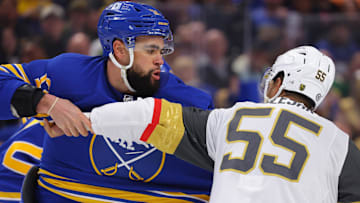 Mar 15, 2025; Buffalo, New York, USA;  Buffalo Sabres left wing Jordan Greenway (12) and Vegas Golden Knights right wing Keegan Kolesar (55) fight during the second period at KeyBank Center. Mandatory Credit: Timothy T. Ludwig-Imagn Images