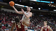 Mar 21, 2025; Raleigh, NC, USA;  Connecticut Huskies forward Alex Karaban (11) drives to the basket against Oklahoma Sooners forward Mohamed Wague (5) during the second half at Lenovo Center. Mandatory Credit: Bob Donnan-Imagn Images