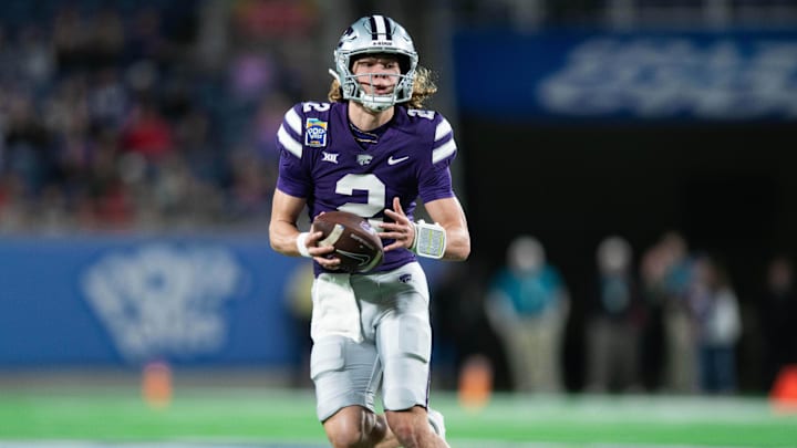 Dec 28, 2023; Orlando, FL, USA; Kansas State quarterback Avery Johnson (2) runs the ball against NC State in the second quarter at Camping World Stadium. Mandatory Credit: Jeremy Reper-Imagn Images