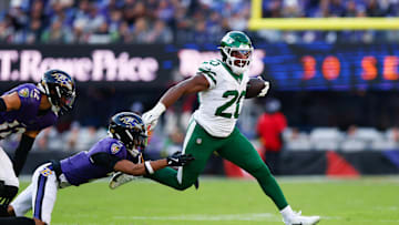 Nov 23, 2025; Baltimore, Maryland, USA;  New York Jets running back Breece Hall (20) rushes as Baltimore Ravens cornerback Nate Wiggins (2) defends during the fourth quarter at M&T Bank Stadium. Mandatory Credit: Peter Casey-Imagn Images