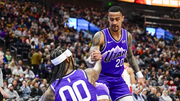 Mar 4, 2024; Salt Lake City, Utah, USA; Utah Jazz forward/center John Collins (20) helps guard Jordan Clarkson (00) off the g