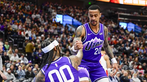 March 4, 2024; Salt Lake City, Utah, USA; Utah Jazz forward/center John Collins (20) helps guard Jordan Clarkson (00) off the g