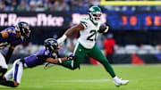 Nov 23, 2025; Baltimore, Maryland, USA;  New York Jets running back Breece Hall (20) rushes as Baltimore Ravens cornerback Nate Wiggins (2) defends during the fourth quarter at M&T Bank Stadium. Mandatory Credit: Peter Casey-Imagn Images