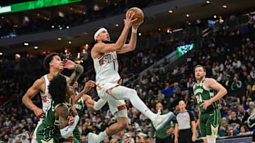 Apr 1, 2025; Milwaukee, Wisconsin, USA;  Phoenix Suns guard Devin Booker (1) takes a shot against Milwaukee Bucks guard Kevin Porter (3) in the second quarter at Fiserv Forum. Mandatory Credit: Benny Sieu-Imagn Images