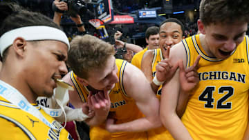 Michigan Wolverines players react after they defeat the Wisconsin Badgers during the 2025 TIAA Big Ten Men’s Basketball Tournament final game on Sunday, March 16, 2025, at Gainbridge Fieldhouse in Indianapolis. Michigan defeated Wisconsin 59-53.