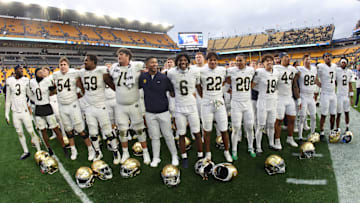Nov 15, 2025; Pittsburgh, Pennsylvania, USA;  Notre Dame Fighting Irish head coach Marcus Freeman (middle) joins his players in singing the victory song after defeating the Pittsburgh Panthers at Acrisure Stadium. Mandatory Credit: Charles LeClaire-Imagn Images