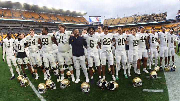 Nov 15, 2025; Pittsburgh, Pennsylvania, USA;  Notre Dame Fighting Irish head coach Marcus Freeman (middle) joins his players in singing the victory song after defeating the Pittsburgh Panthers at Acrisure Stadium. Mandatory Credit: Charles LeClaire-Imagn Images