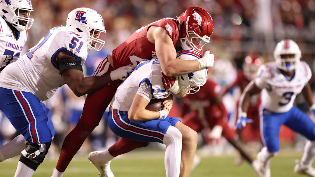 Nov 23, 2024; Fayetteville, Arkansas, USA; Arkansas Razorbacks defensive lineman Landon Jackson (40) sacks Louisiana Tech Bulldogs quarterback Evan Bullock (7) during the fourth quarter