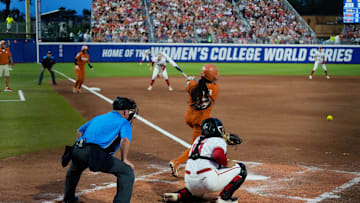 Texas infielder Victoria Hunter hits an infield grounder at the Women's College World Series.