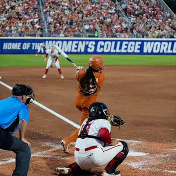 Texas infielder Victoria Hunter hits an infield grounder at the Women's College World Series.