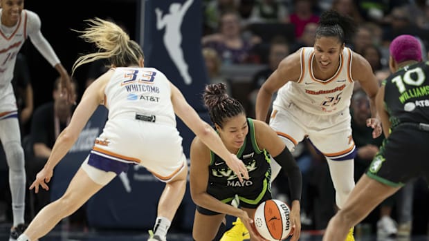 A photo of Napheesa Collier falling down and losing the bal