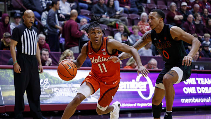 Jan 4, 2025; Blacksburg, Virginia, USA; Virginia Tech Hokies guard Ben Hammond (11) drives to the basket against Miami Hurricanes guard Matthew Cleveland (0) during the first half at Cassell Coliseum. Mandatory Credit: Peter Casey-Imagn Images