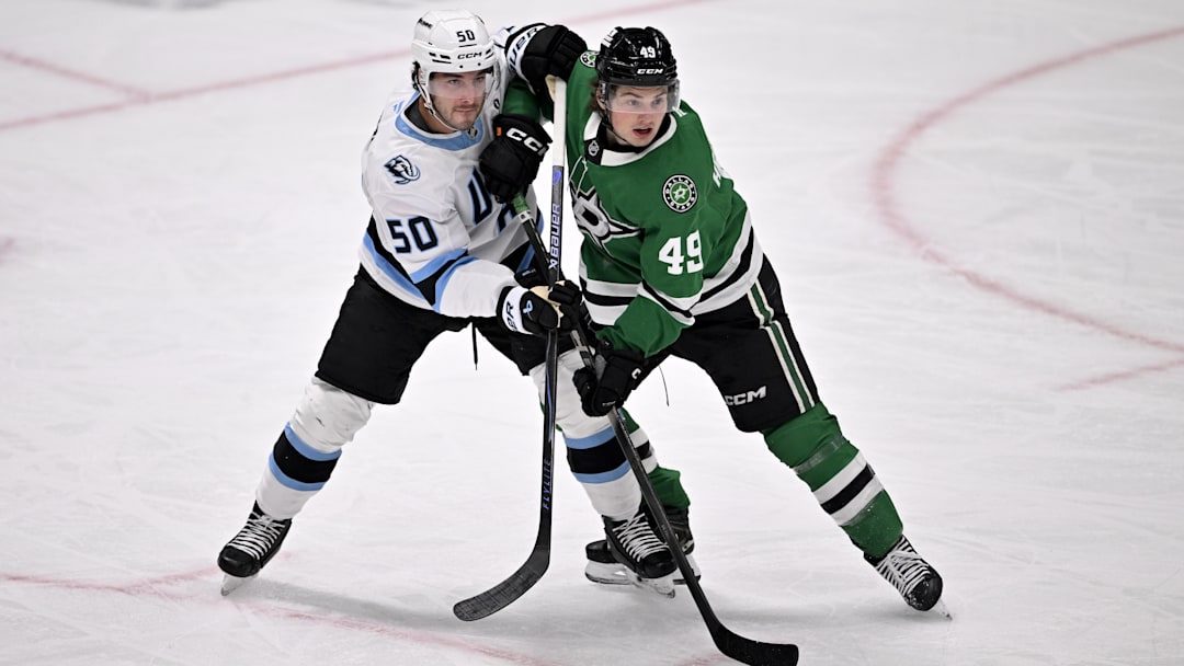 Mar 16, 2026; Dallas, Texas, USA; Utah Mammoth defenseman Sean Durzi (50) and Dallas Stars center Justin Hryckowian (49) battle for position during the first period at the American Airlines Center. Mandatory Credit: Jerome Miron-Imagn Images