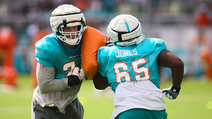 Aug 6, 2024; Miami Gardens, FL, USA; Miami Dolphins offensive tackle Liam Eichenberg (74) works out with guard Robert Jones (65) during a joint practice with the Atlanta Falcons at Baptist Health Training Complex. Mandatory Credit: Sam Navarro-Imagn Images