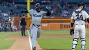 Miami Marlins outfielder Bryan De La Cruz scores the game's only run in a 1-0 extra-innings victory over the Detroit Tigers on Tuesday evening