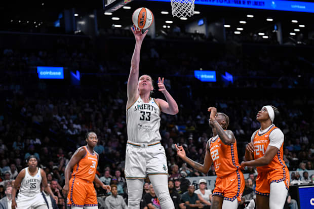 New York Liberty center Emma Meesseman shoots the ball while defended by Connecticut Sun guard Saniya Rivers. 