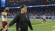 Washington Commanders head coach Dan Quinn walks off the field after the win against Detroit Lions at Ford Field.