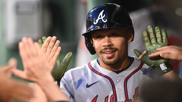 Atlanta Braves catcher Drake Baldwin high-fives teammates in dugout