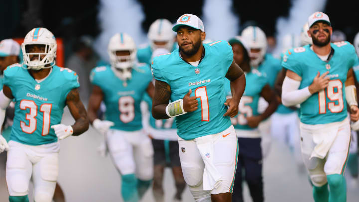 Miami Dolphins quarterback Tua Tagovailoa (1) takes on the field before the game against the Washington Commanders at Hard Rock Stadium.