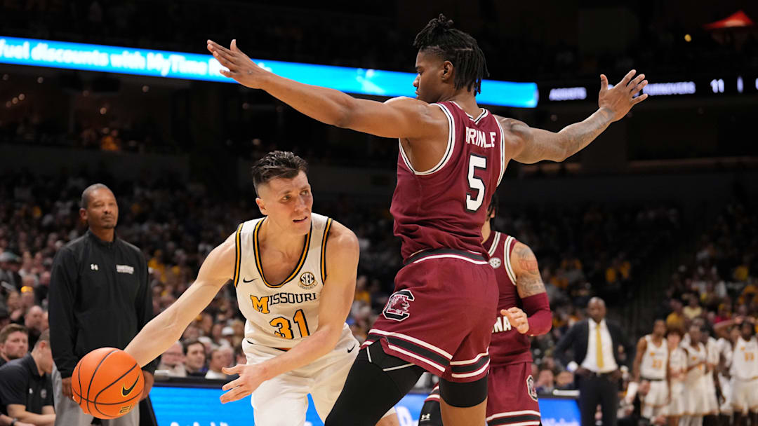 Feb 25, 2025; Columbia, Missouri, USA; Missouri Tigers guard Caleb Grill (31) passes the ball as South Carolina Gamecocks forward Nick Pringle (5) defends during the second half at Mizzou Arena. Mandatory Credit: Denny Medley-Imagn Images