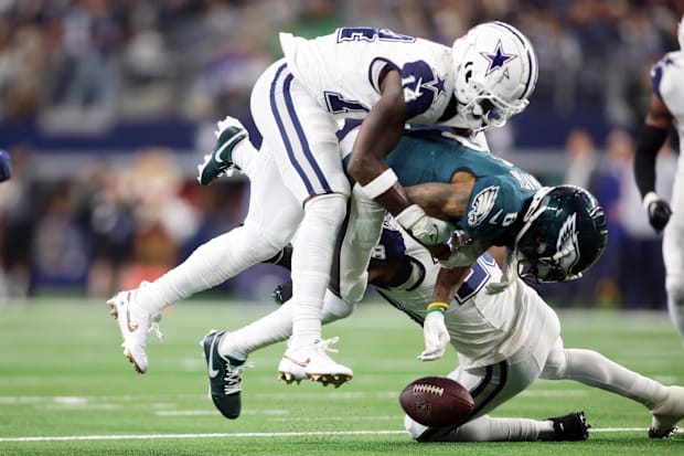 Philadelphia Eagles wide receiver DeVonta Smith fumbles the ball after being hit by Dallas Cowboys safety Markquese Bell