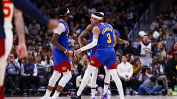 Apr 6, 2024; Denver, Colorado, USA; Denver Nuggets guard Reggie Jackson (7), forward Justin Holiday (9) and guard Julian Strawther (3) celebrate after a three-point shot against the Atlanta Hawks in the first half at Ball Arena. Mandatory Credit: Michael Ciaglo-USA TODAY Sports