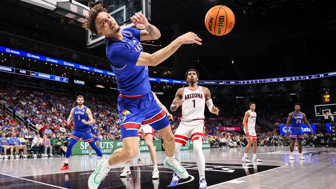 Mar 13, 2025; Kansas City, MO, USA; Kansas Jayhawks guard Zeke Mayo (5) saves an out of bounds ball during the second half against the Arizona Wildcats at T-Mobile Center. Mandatory Credit: William Purnell-Imagn Images