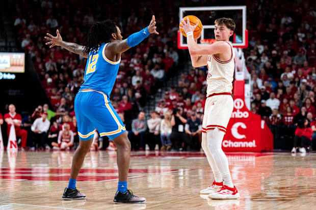 Nebraska Cornhuskers guard Connor Essegian (0) looks to pass against UCLA Bruins guard Sebastian Mack (12) during the first h