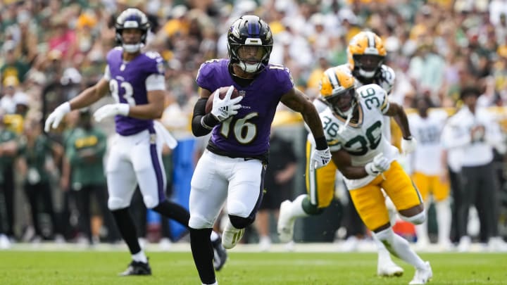 Aug 24, 2024; Green Bay, Wisconsin, USA;  Baltimore Ravens wide receiver Tylan Wallace (16) rushes with the football after catching a pass before scoring a touchdown during the second quarter against the Green Bay Packers at Lambeau Field. Mandatory Credit: Jeff Hanisch-USA TODAY Sports