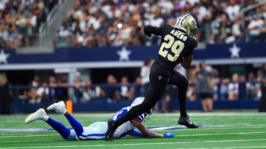 Sep 15, 2024; Arlington, Texas, USA;  New Orleans Saints cornerback Paulson Adebo (29) intercepts a ball intended for Dallas Cowboys wide receiver Jalen Brooks (83) during the first half at AT&T Stadium. Mandatory Credit: Kevin Jairaj-Imagn Images