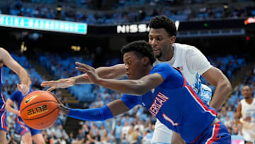 Nov 15, 2024; Chapel Hill, North Carolina, USA; American University Eagles guard Elijah Stephens (1) and North Carolina Tar Heels forward Jalen Washington (13) reach for the ball in the second half at Dean E. Smith Center. Mandatory Credit: Bob Donnan-Imagn Images