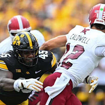 Sep 14, 2024; Iowa City, Iowa, USA; Iowa Hawkeyes defensive lineman Deontae Craig (45) pressures Troy Trojans quarterback Matthew Caldwell (12) during the first quarter at Kinnick Stadium. Mandatory Credit: Jeffrey Becker-Imagn Images