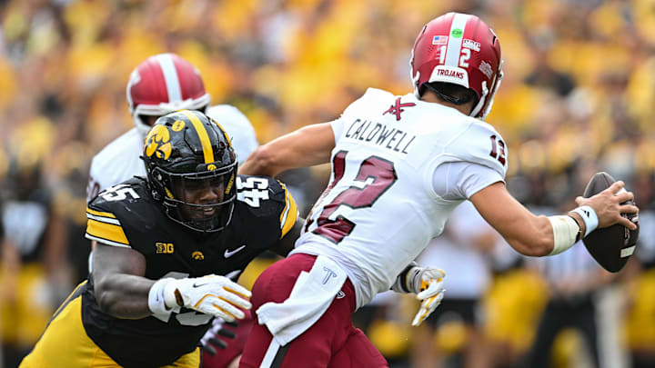 Sep 14, 2024; Iowa City, Iowa, USA; Iowa Hawkeyes defensive lineman Deontae Craig (45) pressures Troy Trojans quarterback Matthew Caldwell (12) during the first quarter at Kinnick Stadium. Mandatory Credit: Jeffrey Becker-Imagn Images