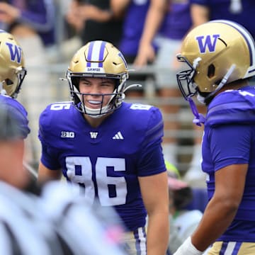  Huskies tight end Decker DeGraaf (86) celebrates a 41- touchdown catch against Eastern Michigan with his teammates.