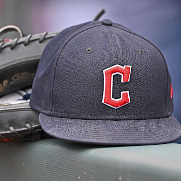 Jun 27, 2024; Kansas City, Missouri, USA; A general view a Cleveland Guardians hat and glove on the dugout railing  before a game against the Kansas City Royals at Kauffman Stadium. 