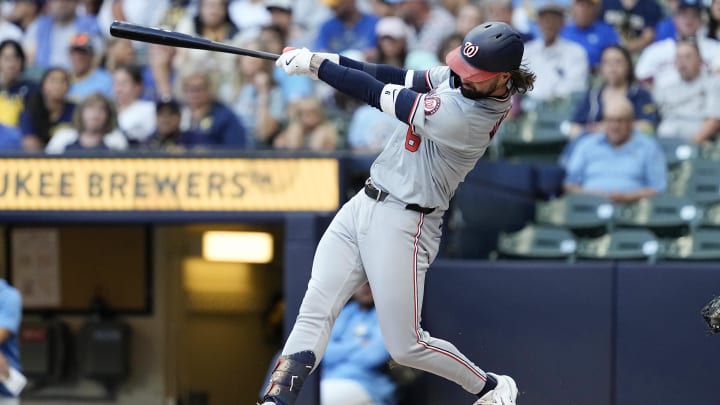 Jul 12, 2024; Milwaukee, Wisconsin, USA;  Washington Nationals designated hitter Jesse Winker (6) hits an RBI double during the first inning against the Milwaukee Brewers at American Family Field. 