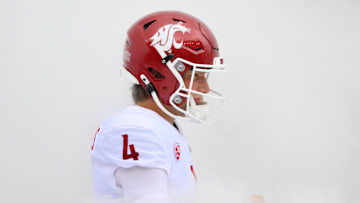 Sep 14, 2024; Seattle, Washington, USA; Washington State Cougars quarterback Zevi Eckhaus (4) walks through smoke before the game against the Washington Huskies at Lumen Field. Mandatory Credit: Steven Bisig-Imagn Images