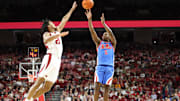 Jan 8, 2025; Fayetteville, Arkansas, USA; Ole Miss Rebels guard Jaylen Murray (5) shoots in the first half as Arkansas Razorbacks guard D.J. Wagner (21) defends at Bud Walton Arena. Mandatory Credit: Nelson Chenault-Imagn Images