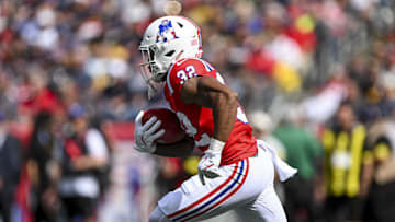 Sep 21, 2025; Foxborough, Massachusetts, USA; New England Patriots running back Treveyon Henderson (32) returns the ball during the first quarter at Gillette Stadium. Mandatory Credit: Brian Fluharty-Imagn Images