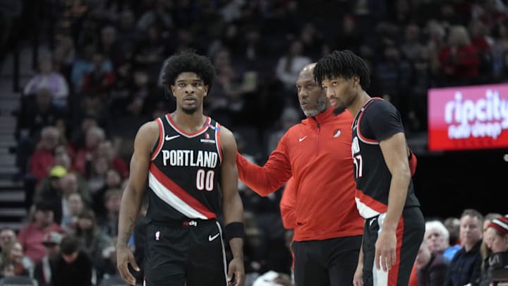 Jan 14, 2025; Portland, Oregon, USA; Portland Trail Blazers head coach Chauncey Billups talks to Scoot Henderson (00) and Shaedon Sharpe (17) during the first half against the Brooklyn Nets at Moda Center. Mandatory Credit: Soobum Im-Imagn Images
