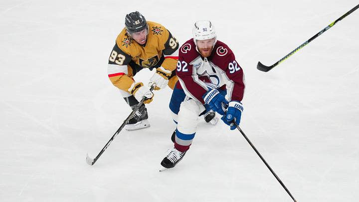 May 26, 2026; Las Vegas, Nevada, USA; Colorado Avalanche left wing Gabriel Landeskog (92) controls the puck against Vegas Golden Knights right wing Mitch Marner (93) during the third period in game four of the Western Conference Final of the 2026 Stanley Cup Playoffs at T-Mobile Arena. Mandatory Credit: Stephen R. Sylvanie-Imagn Images