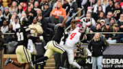 Nov 8, 2025; West Lafayette, Indiana, USA; Ohio State Buckeyes wide receiver Jeremiah Smith (4) makes a catch as Purdue Boilermakers defensive back Hudauri Hines (4) defends during the first quarter at Ross-Ade Stadium. Mandatory Credit: Marc Lebryk-Imagn Images
