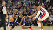 Dec 26, 2024; Sacramento, California, USA; Sacramento Kings guard Malik Monk (0) controls the ball against Detroit Pistons guard Jaden Ivey (23) during the fourth quarter at Golden 1 Center. Mandatory Credit: Kelley L Cox-Imagn Images