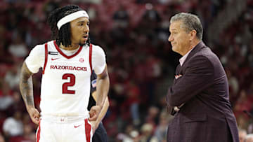 Nov 22, 2024; Fayetteville, Arkansas, USA; Arkansas Razorbacks guard Boogie Fland (2) talks to head coach John Calipari during the first half against the Little Rock Trojans at Bud Walton Arena. Mandatory Credit: Nelson Chenault-Imagn Images